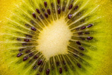 Heart of kiwi fruit with seeds close-up in a cut.