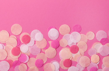 Pink confetti on pastel pink background. Festive background  for your design.