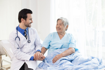 Doctor and early woman smile together at hospital, people with medicine concept.