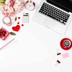 Feminine desk workspace frame with pink beige floral bouquet, red coffee cup, smartphone, accessories and notebook on white background with copy space. Flat lay. Top view. Valentines day background.