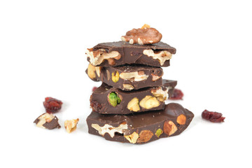 Dark chocolate bark with mixed nuts on white background - isolated