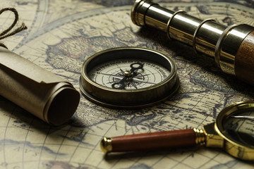 Retro compass with old map and spyglass