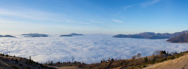 Drone aerial view to the Po plain and Seriana valley. The fog covers all the villages and the Padana plain