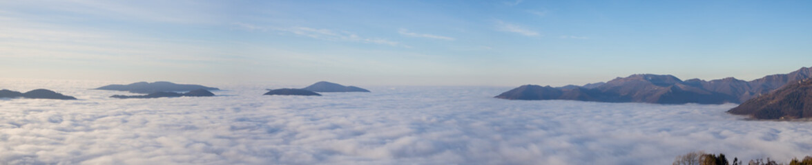 Fototapeta premium Drone aerial view to the Po plain and Seriana valley. The fog covers all the villages and the Padana plain