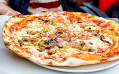 Appetizing pizza with seafood on a plate