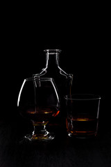 Glass of whiskey with smoking cigar.