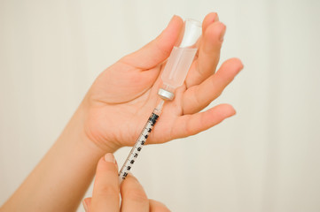 A girl fills a syringe for insulin injections. Diabetes. The short-acting insulin. Insulin injection at home.