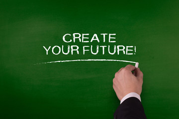 CREATE YOUR FUTURE! word written by hand on blackboard