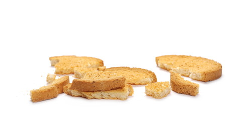 Integral crumbled rusks pile with wholewheat flour, bread slices isolated on white background
