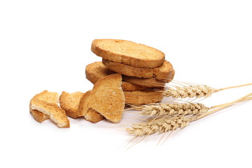 Integral wholewheat rusks, bread slices and ears of wheat isolated on white background