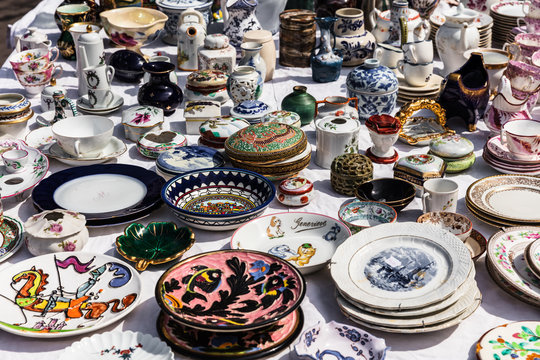 Old vintage objects and furniture at a garage sale at the flea market in Paris. France