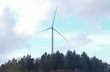 wind turbine in a forest, cloud-sky