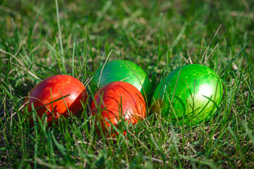 Group of painted easter eggs on the bright spring grass. Easter hunt. Closeup