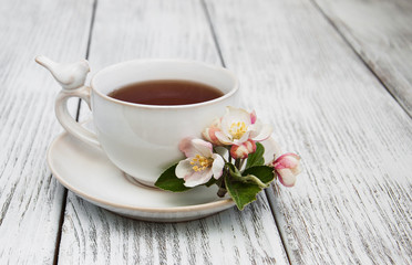 Naklejka na ściany i meble cup of tea with apple blossoms