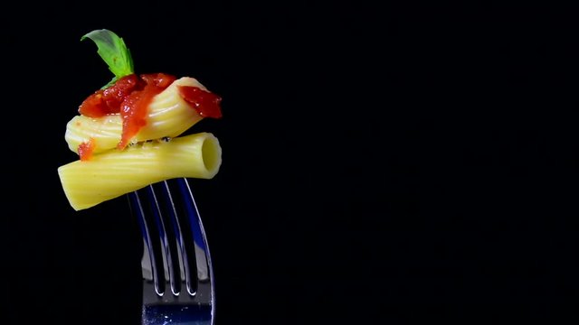Rigatoni, pasta on black background