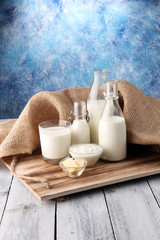 Fototapeta na wymiar milk products. tasty healthy dairy products on a table on. sour cream in a bowl, cottage cheese bowl, cream in a a bank and milk jar, glass bottle and in a glass