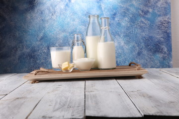 milk products. tasty healthy dairy products on a table on. sour cream in a bowl, cottage cheese bowl, cream in a a bank and milk jar, glass bottle and in a glass