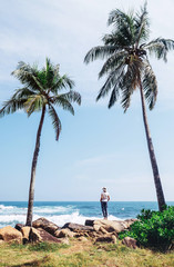 Southern point Sri Lanka island - Dondra cape, woman stands on coast and looks on horizont line