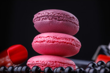 Macaroons of pink shades with a tube of varnish for an ideal manicure and a thread of beads.