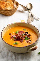 Hot pumpkin cream soup with beans and chorizo