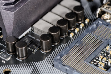 Naklejka premium Close up on the cpu socket, focus on the surrounding capacitors