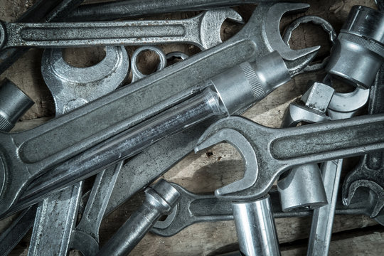 set of metal wrench rests on wooden background abstraction