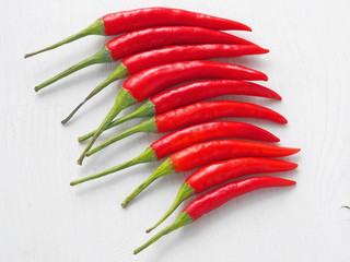 Red chili peppers in a diagonal.  Culinary background. Top view.
