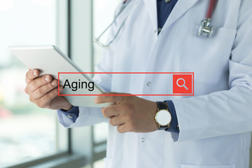 DOCTOR USING TABLET PC SEARCHING AGING ON WEB