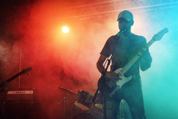 The guitarist performs on stage.