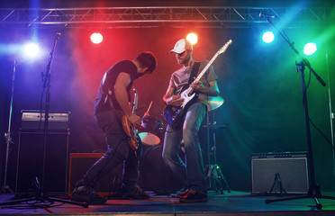 Naklejka na ściany i meble Guitarist and bass player perform on stage.