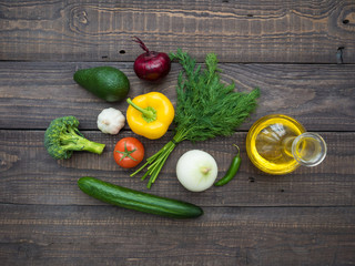 Fresh vegetables and decanter with sunflower oil on the table