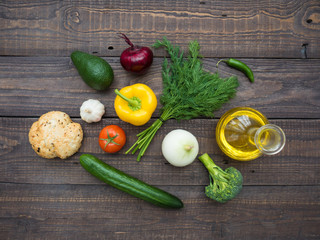 Fresh vegetables, decanter with sunflower oil and bread on the table
