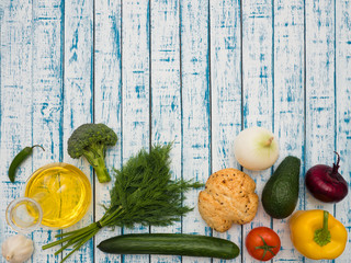 Fresh vegetables, decanter with sunflower oil and bread on the table