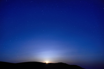 Obraz na płótnie Canvas Blue dark night sky with many stars. Moon rising. Space background
