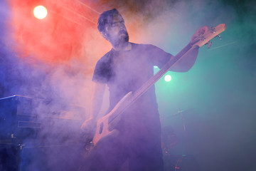 Bass player perform on stage.