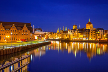 Architecture of the old town in Gdansk over Motlawa river at dusk, Poland