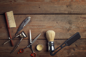 Vintage tools of barber shop on wooden background