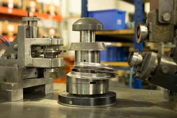 Cutting a piece of metal in a heavy duty metal processing machine