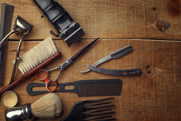 Vintage tools of barber shop on wooden background