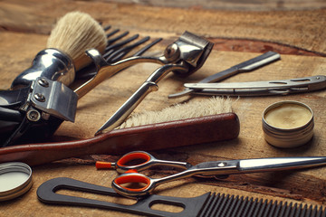 Vintage tools of barber shop on wooden background