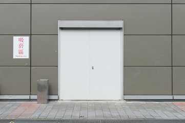 Smoking area zone:Unidentified poeple smoke in designated smoking area . Smoking and waking is strictly prohibited in most of the public area