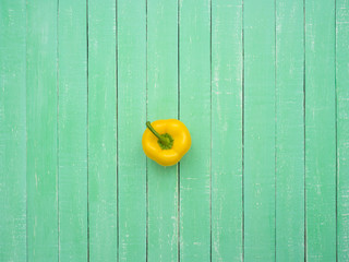 Yellow Bulgarian pepper on a wooden table