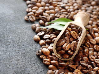 Coffee beans and an  wooden scoop