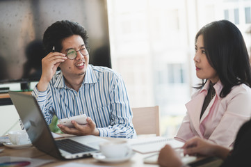 Man and woman workers talking in coffee shop