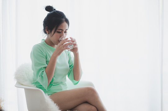 Young Asian woman drinking coffee