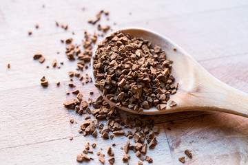 Instant Granulated Coffee Powder on Wooden Spoon.