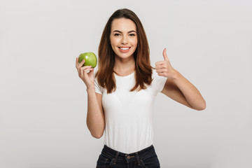 Portrait of a healthy young woman holding green apple