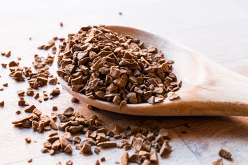 Instant Granulated Coffee Powder on Wooden Spoon.