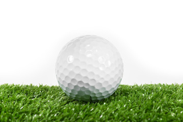 The white ball placed on the green lawn.