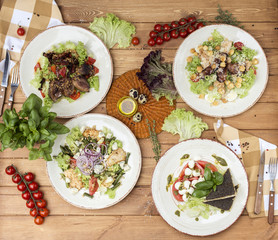 Different kinds of useful salads with meat and poultry. Top view